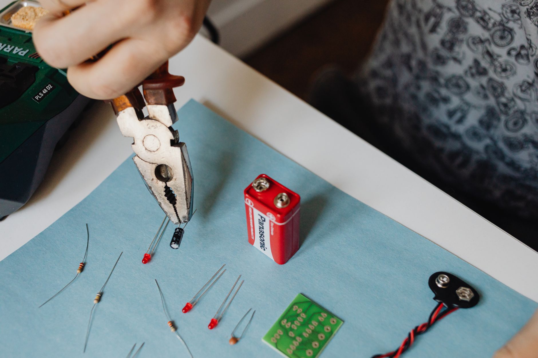 Pliers and electrical components on a work mat